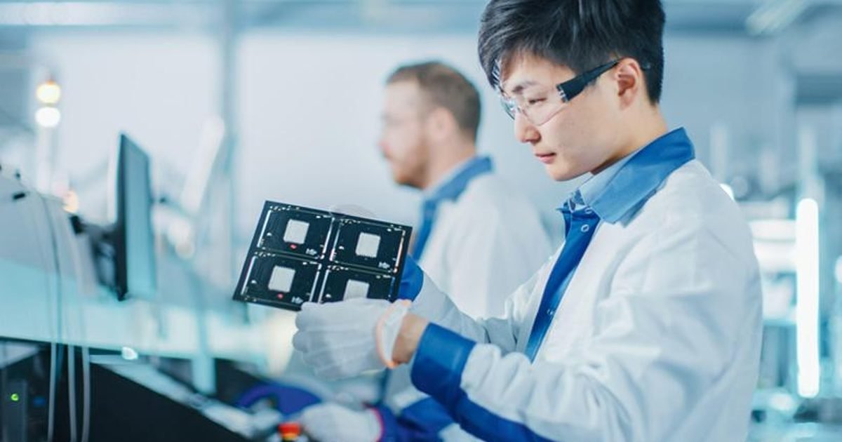 Application engineer inspecting a cleaned printed circuit board