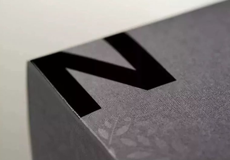 Close-up of an SMT stencil showing laser-cut apertures in a stainless steel sheet